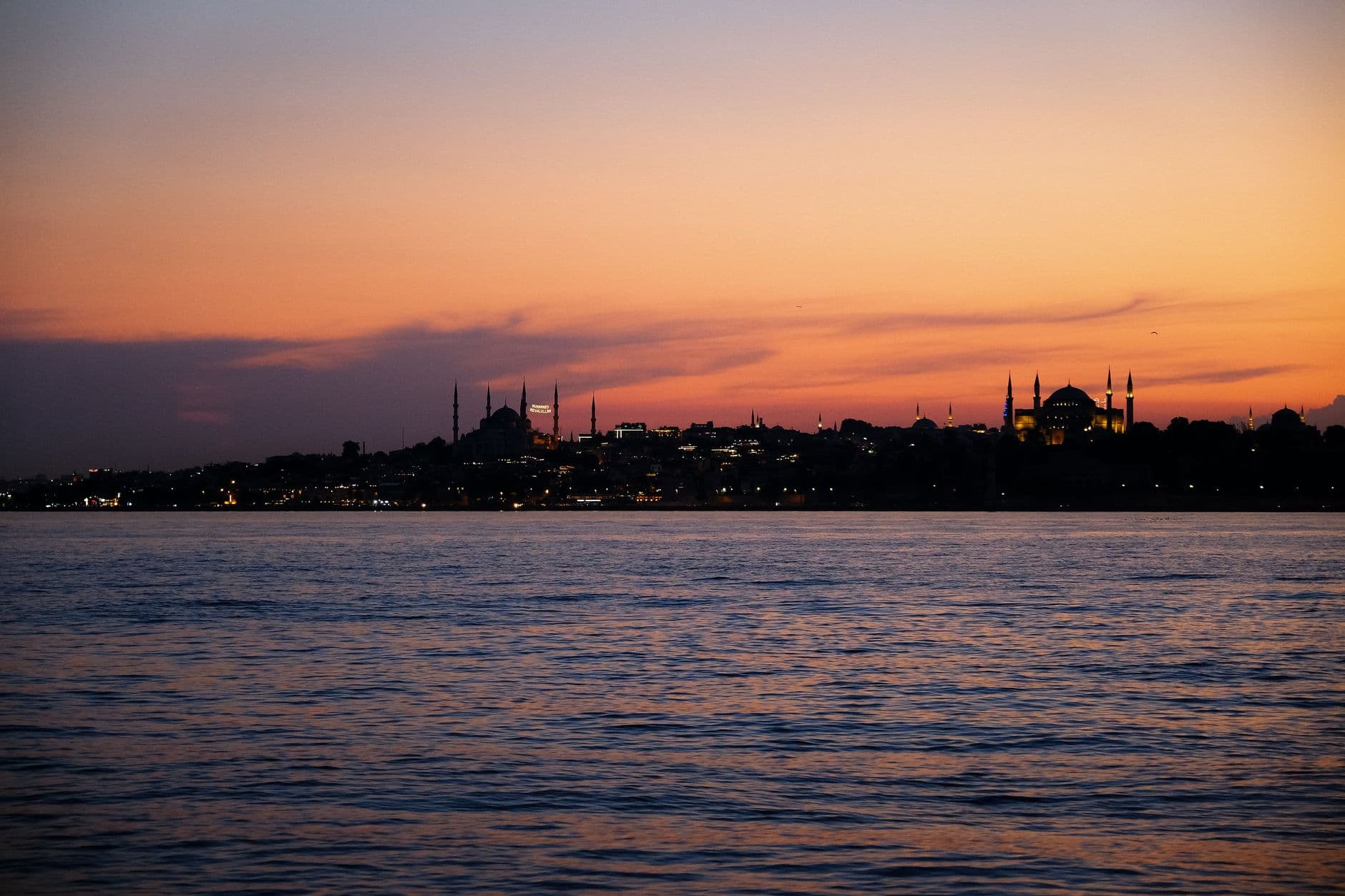 Beautiful Istanbul skyline over water at twilight with mosques in view.
