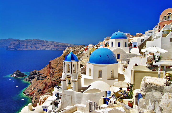 Whitewashed houses and blue-domed churches overlooking the Aegean Sea in Santorini