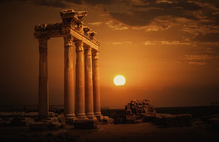 Beautiful view of Side Ancient City featuring historic Roman columns, archaeological ruins, and ancient Mediterranean atmosphere in Türkiye.