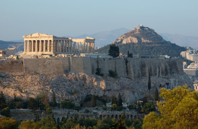 View of the Acropolis Hill in Athens overlooking the city, showcasing ancient ruins, historic architecture, and Greece’s iconic cultural landscape.