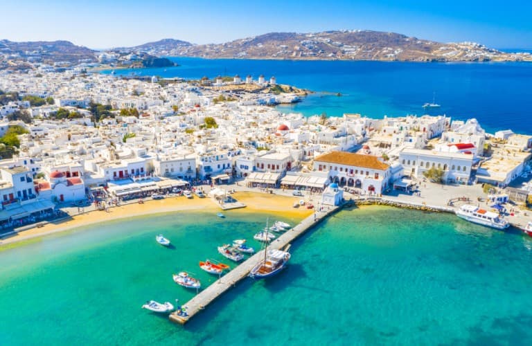 Mykonos Island in Greece with beautiful blue sea, whitewashed houses and traditional island scenery